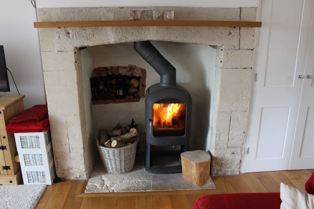Period stone fireplace with wood burning stove