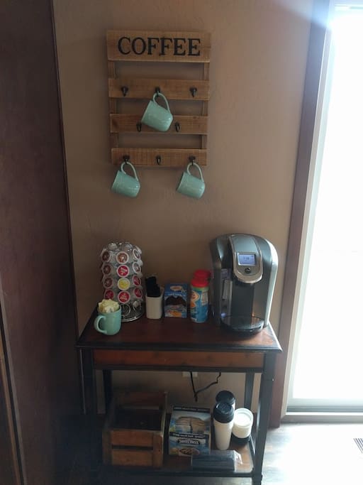 Coffee bar with a Keurig 2.0 & stocked K-cups and creamer/sugar.