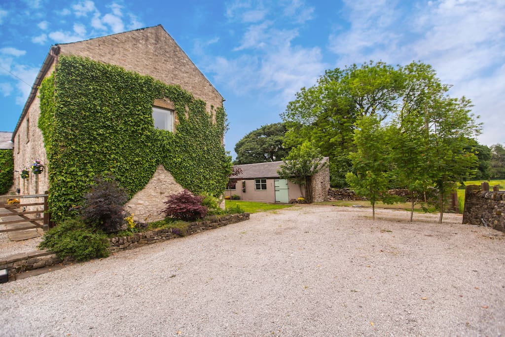 The Old Barn (ivy covered building, left) has ample free parking outside of the property.