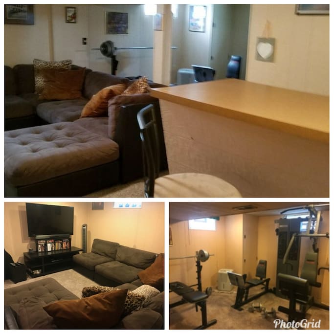 Cozy fully finished basement with bar, exercise area, and tv area.