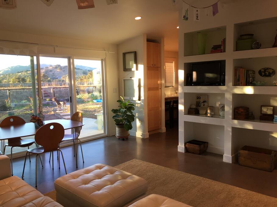 The living/dining room has a small TV, creative decor and a beautiful view