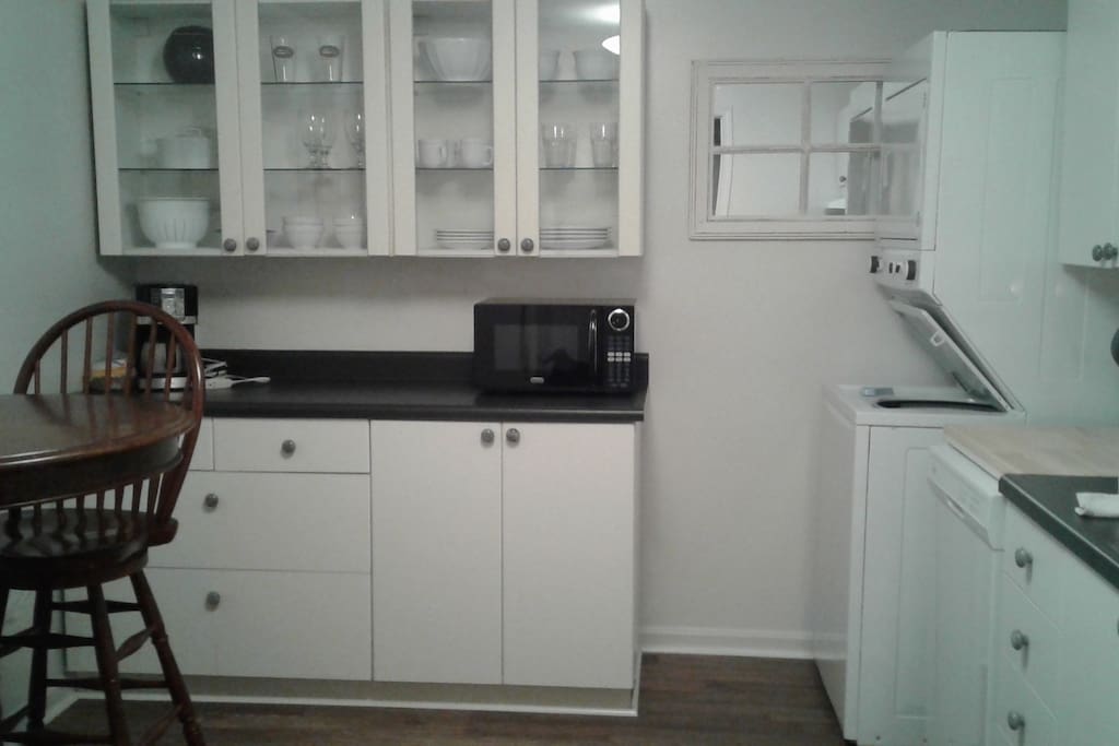 Fully equipped kitchen with full size fridge, stove and laundry