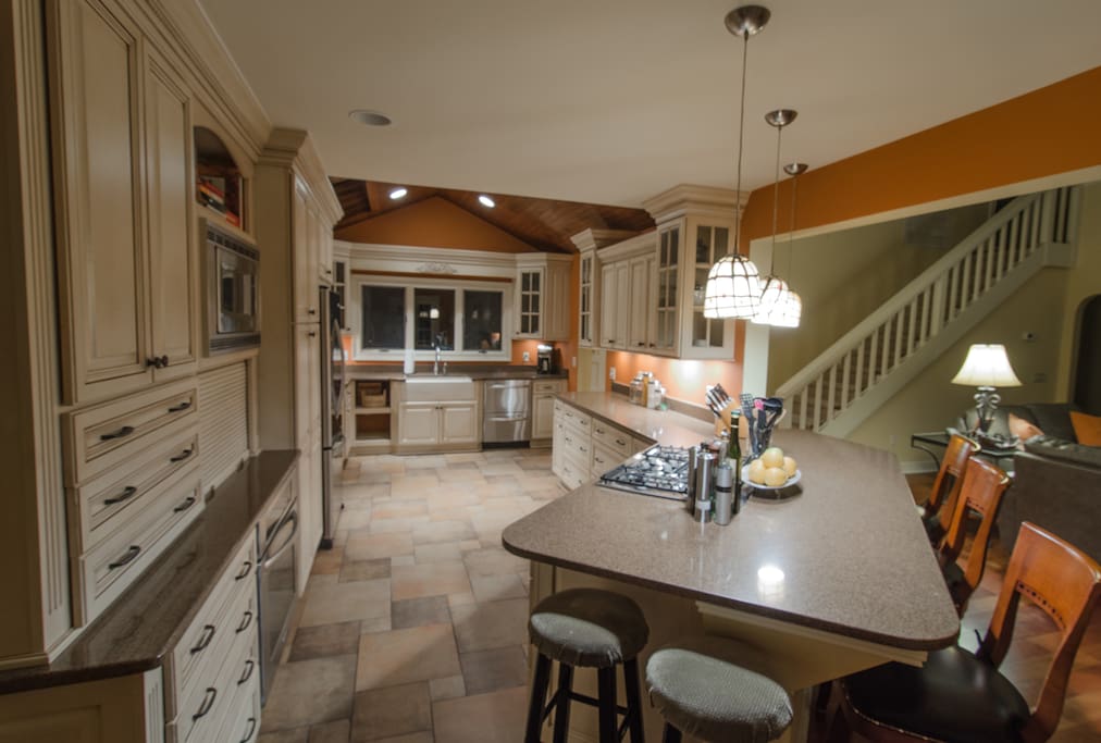 A large kitchen with a counter bar makes for a nice transition between the kitchen and living room.