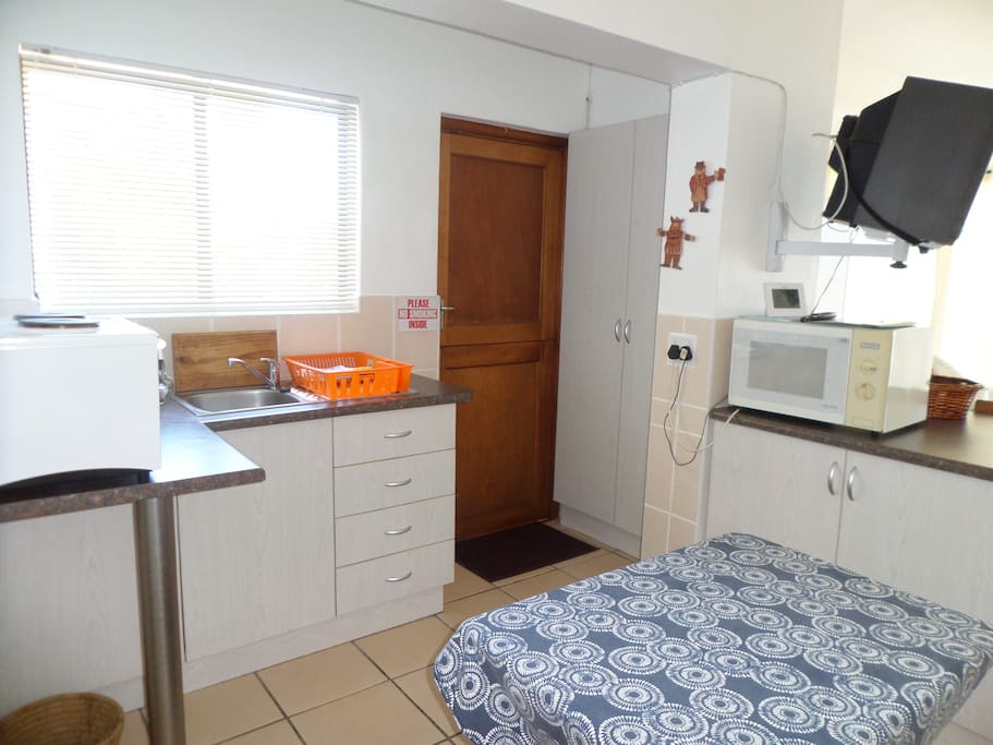 Unit 2: Kitchenette with salton stove, wash up and table.