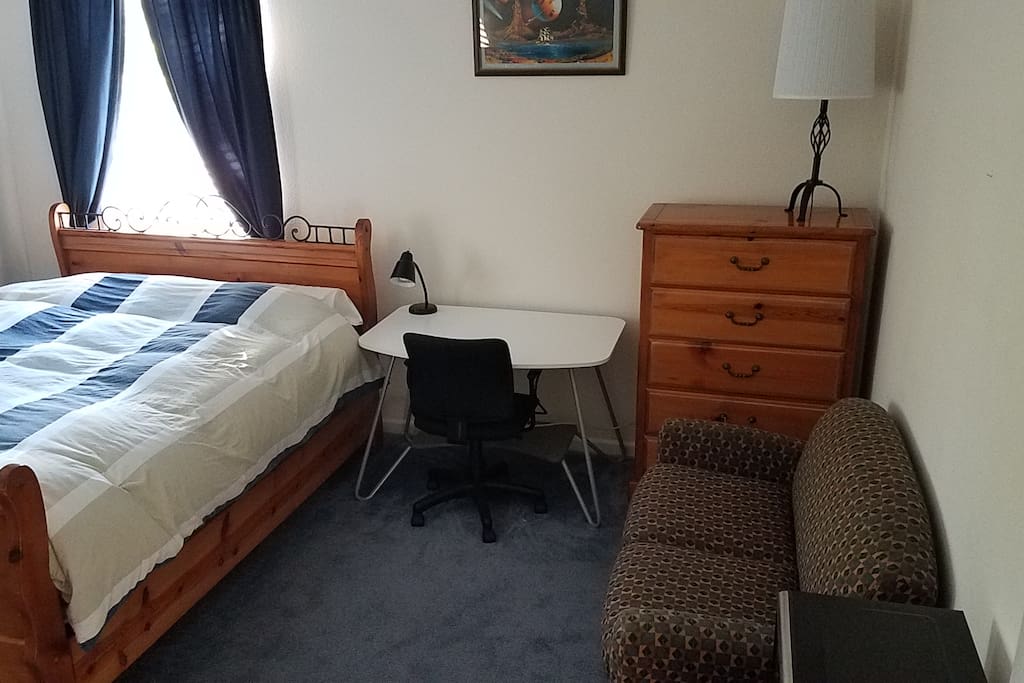 Furnished room includes queen bed, sofa, 2 dressers, 2 end tables.