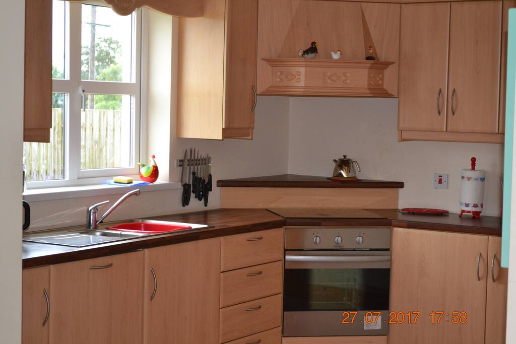 Fully fitted kitchen with fridge/freezer, induction hob, oven, microwave, washing machine and dishwasher