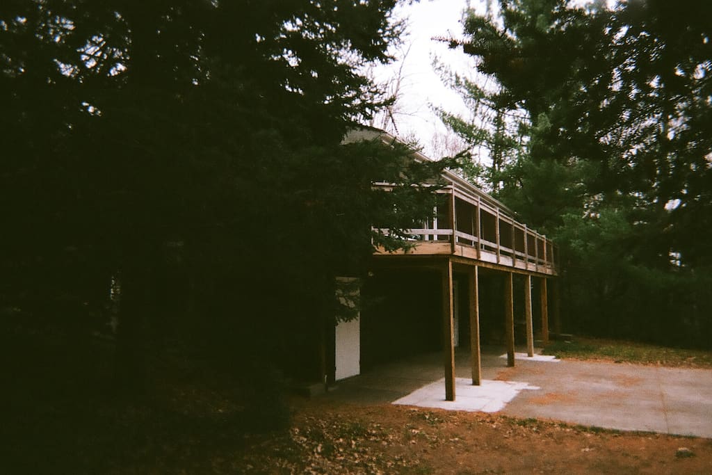 Big deck and basketball hoop on cement pad.