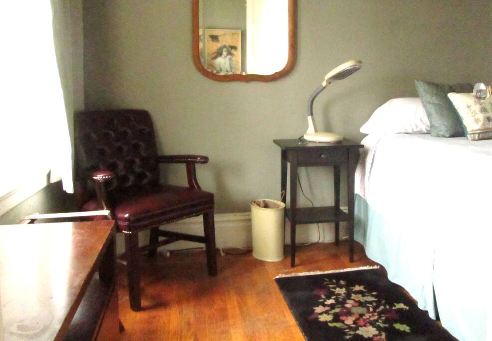 Guest bedroom has two large windows at left in photo.