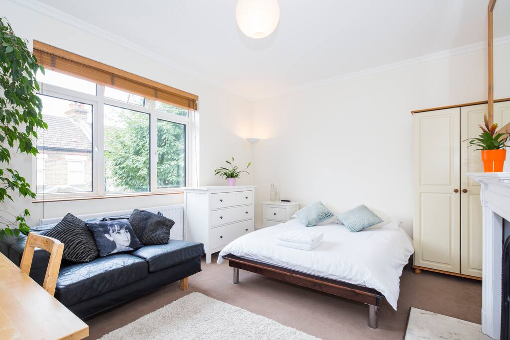 Bedroom 3 - The largest, with original fireplace, huge south facing window, plenty of storage, HDTv and your own dining table / desk / study.