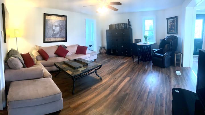 ห้องนั่งเล่นที่กว้างขวางมีเก้าอี้นวดที่น่าตื่นตาตื่นใจทีวีจอใหญ่และโต๊ะเกม