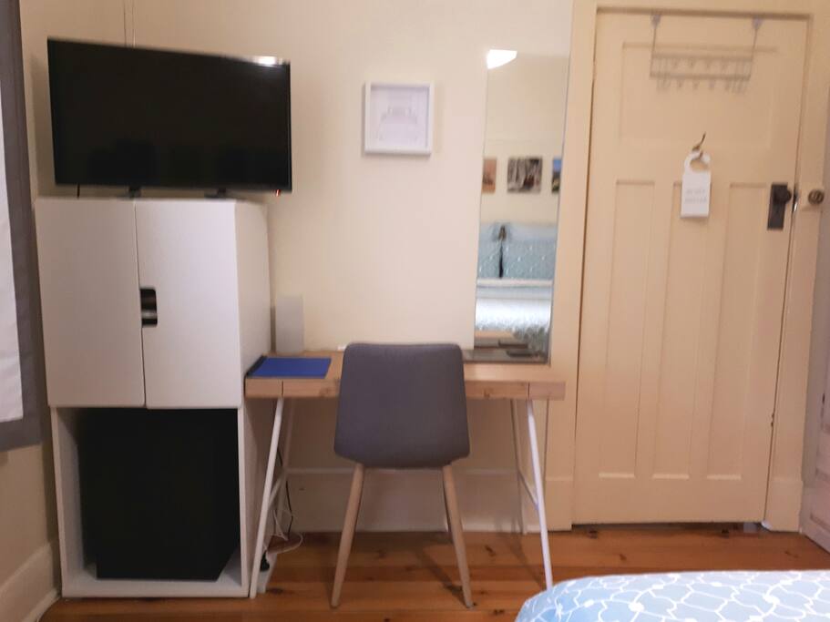 Work space, cupboard, t.v. laundry basket.