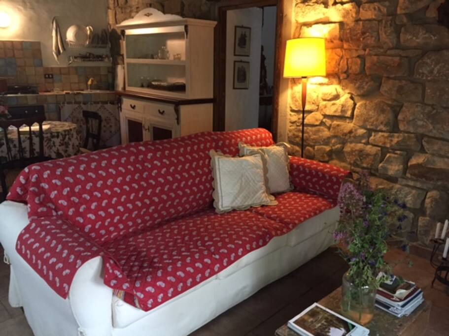 Living room and look at kitchen. This couch faces the living room fireplace