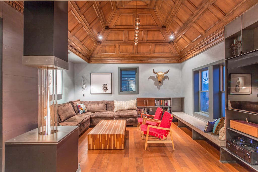 Family room with sectional couch, heated stone bench, and large flat screen TV. Enjoy premium cable, Apple TV, Sonos, and Bluray.