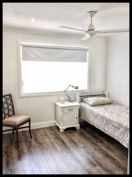 Single bedroom with lots of light , single bed, bedside table and chair. Mirrored double wardrobe.