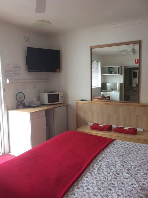 Main bedroom showing TVCorner, blanket box and tea making facilities