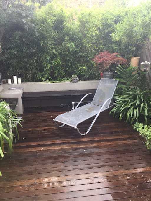 Secluded garden with a variety of plants, an umbrella when needed & a BBQ upon request.