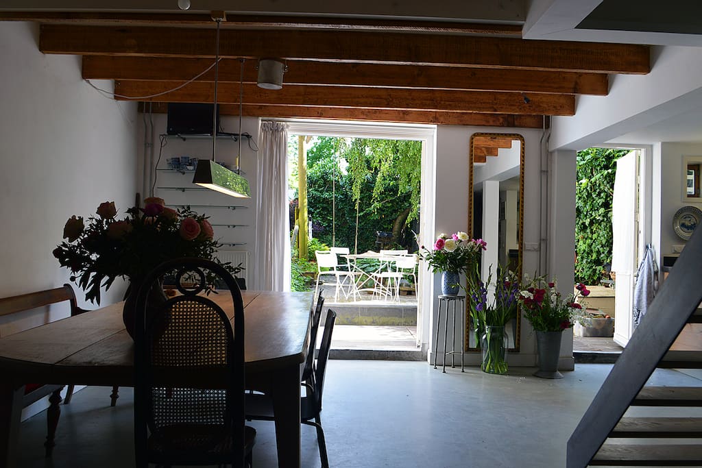View from the living area towards the kitchen, dinner table and garden