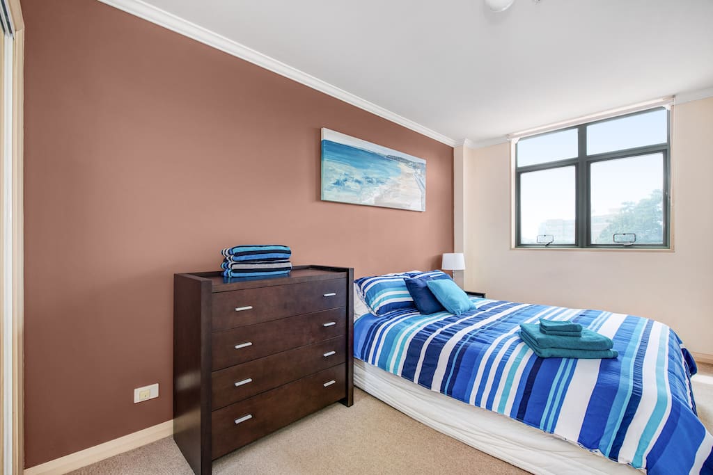 Main bedroom with built-in robe and window looking over Pacific Park