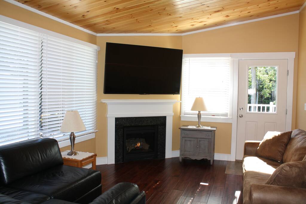 The living area features a 70 inch HDTV, propane fireplace with granite surround, Italian leather sectional and a queen pull out sleeper sofa.