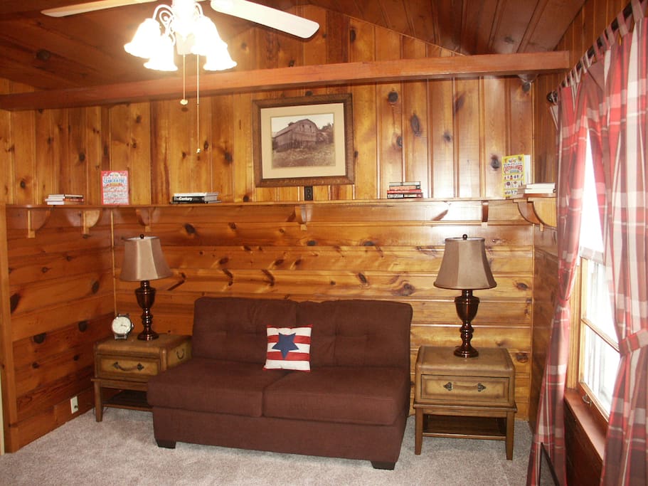 Relax in comfort in the den which attains a cabin-in-the-woods feeling.
