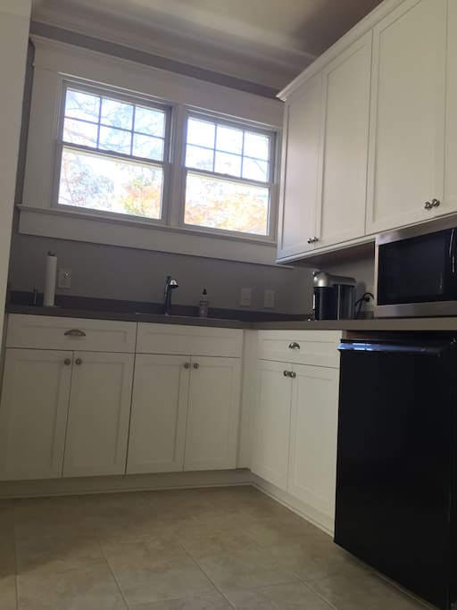 Kitchenette with microwave, refrigerator, and Nespresso machine