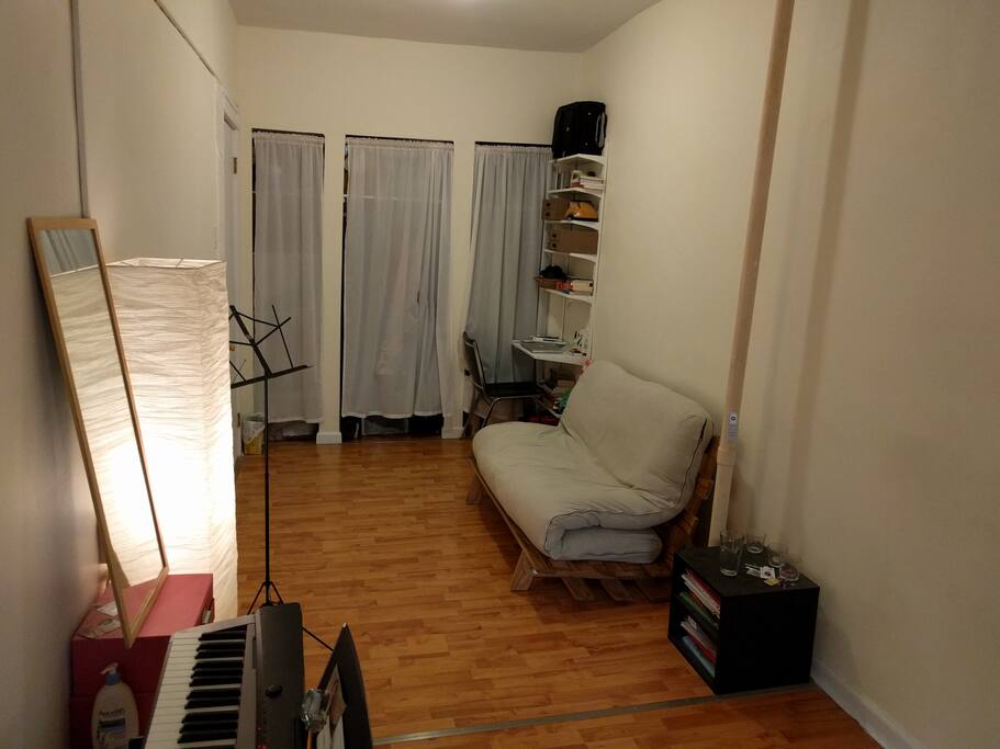 A futon that folds away for extra space, small desk for your work.