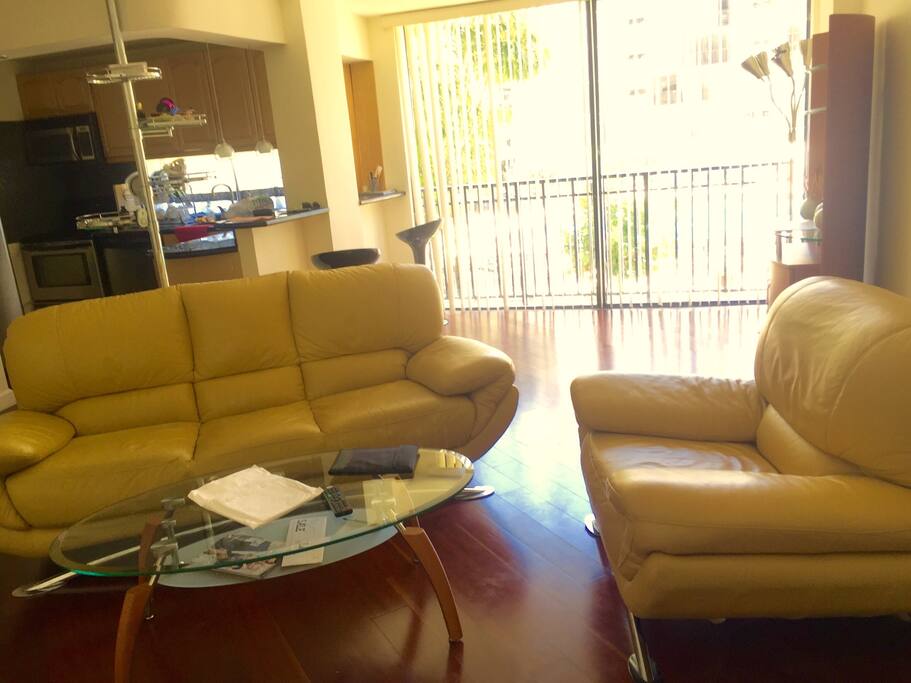 Living room has floor to ceiling windows facing the pool.