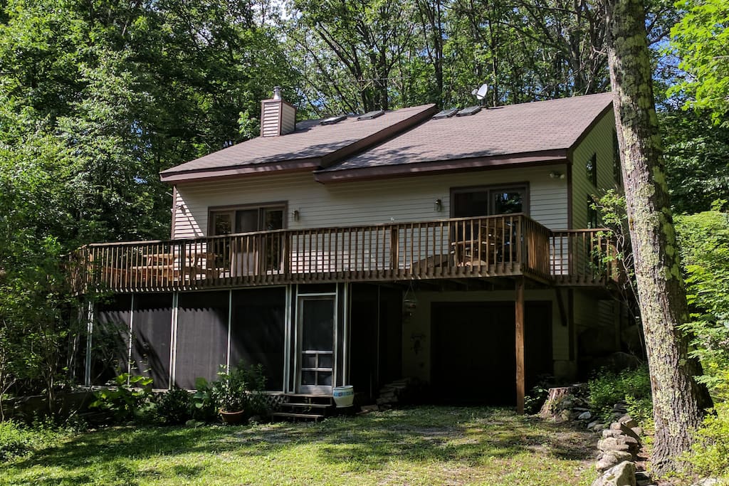 Two level wraparound deck welcomes you to your home in the woods