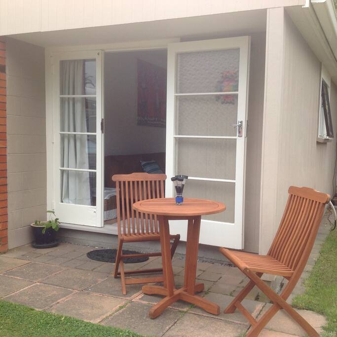 Outside guest bedroom with table and chairs for guests use.