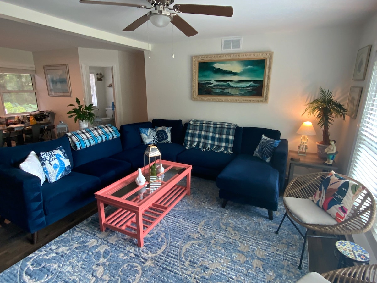 Living Room with coffee table and room for 8 people.   Dining room is off to the left in the picture