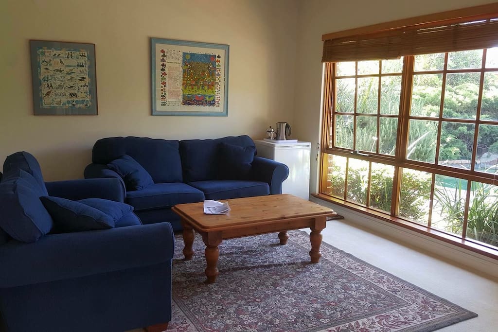 Comfortable poolside living area with fridge and tea/coffee facilities