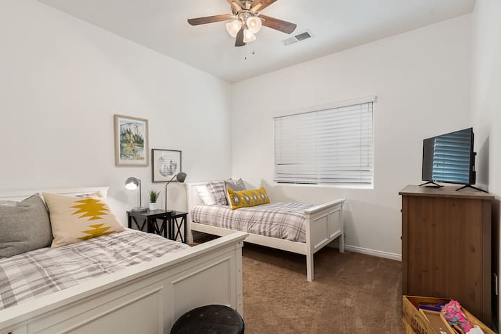 Bedroom #3.  Two single beds and tv.  Also contains some toys for any kids who may be visiting!