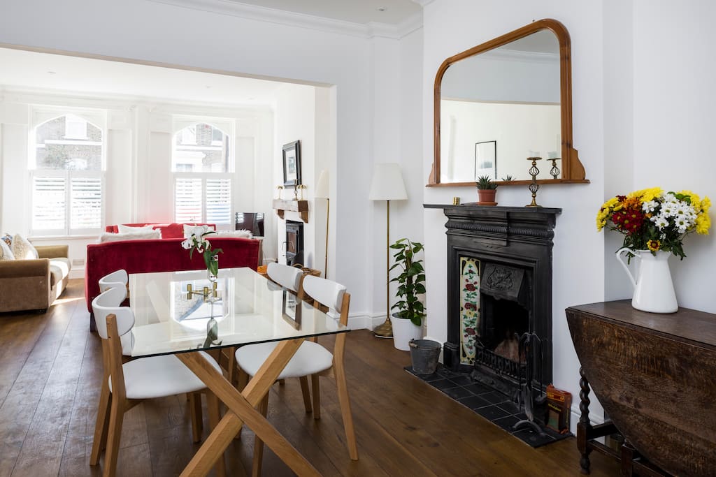 It is an open-plan space with a dining table at one end of the room.