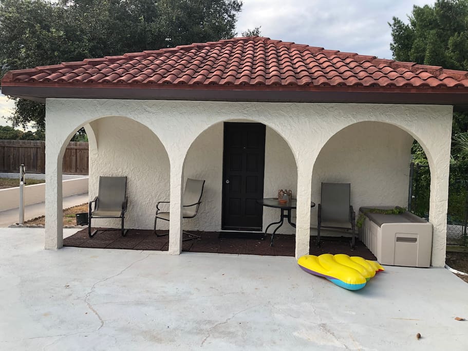 Back of house door to the pool , covers and sitting area.