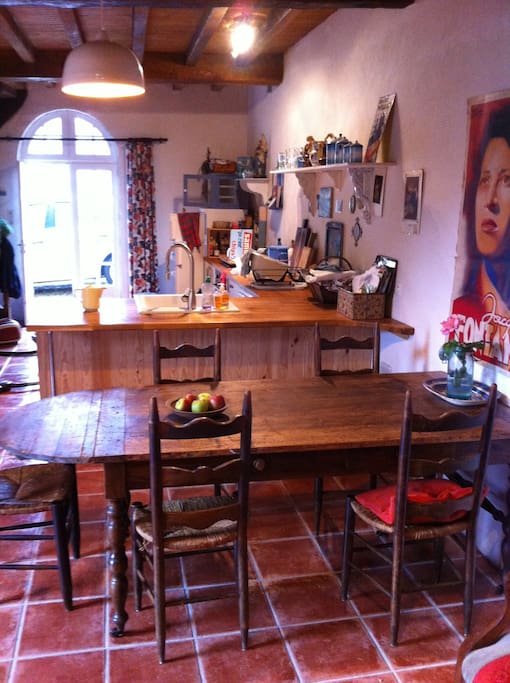 A genuine ancient farm table takes centre place in the dining area
