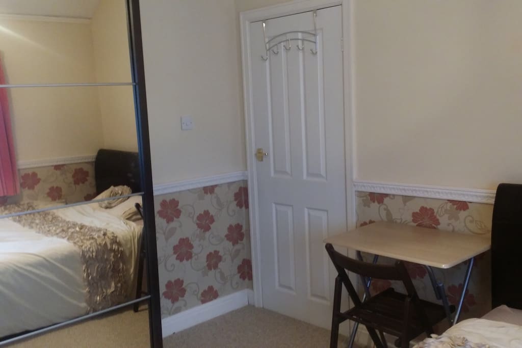 Newly refurbished room with folding chair and table.