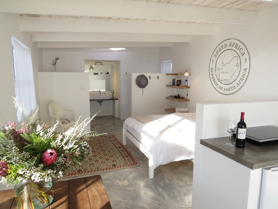 Open plan cottage bedroom and bath beyond; wheelchair accessible throughout