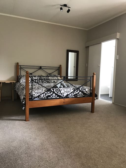 Large comfortable bed with clean linen and towels