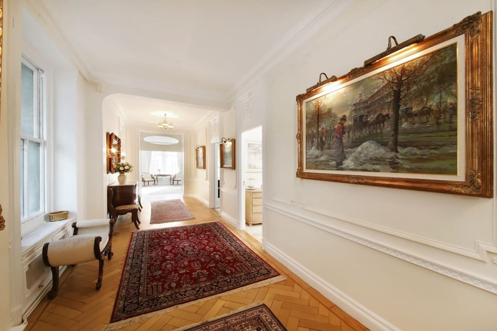 Hallway lounge with oil paintings connects rooms