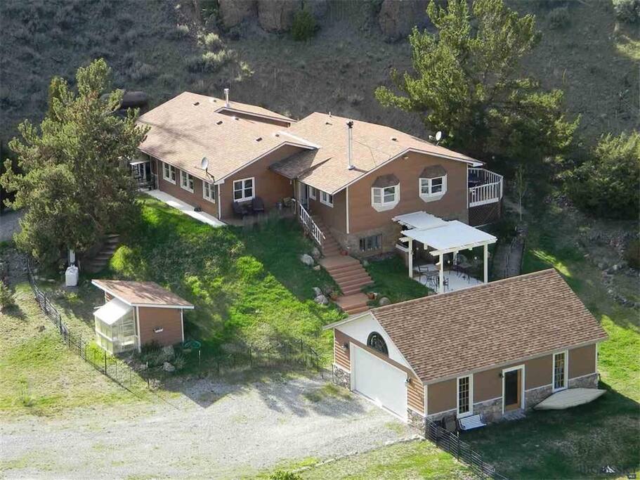 The house, garage, and greenhouse