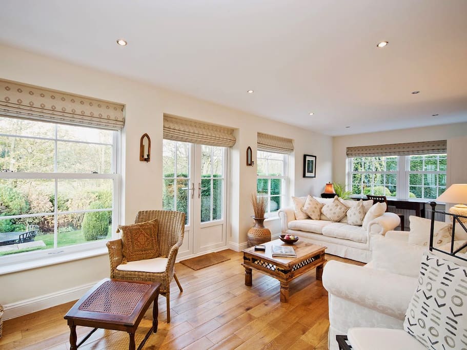 Light and airy orangery style lounge with french doors leading into large garden