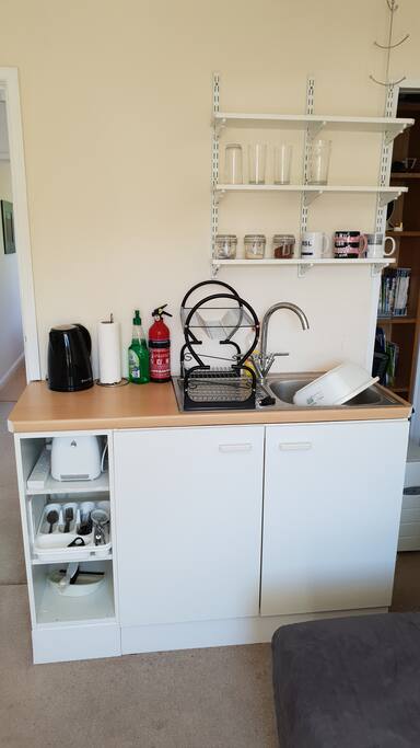 The sink, tea making kit, toaster and crockery cupboard
