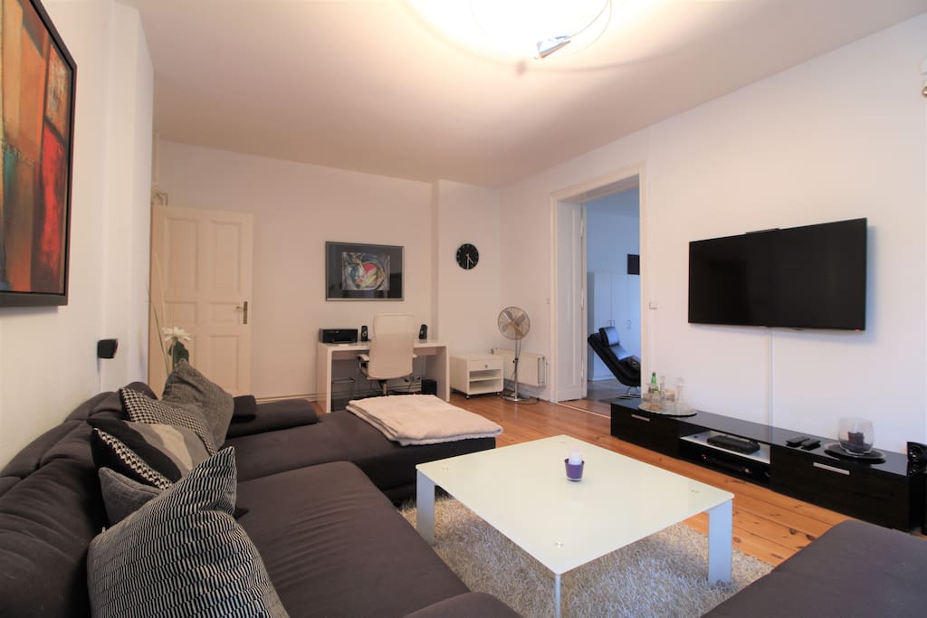 Bright & cozy living room with creative decor, modern TV, etc.