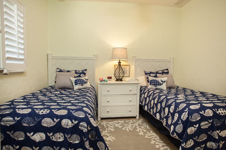 Kids' room with two twins and children's dinnerware stocked