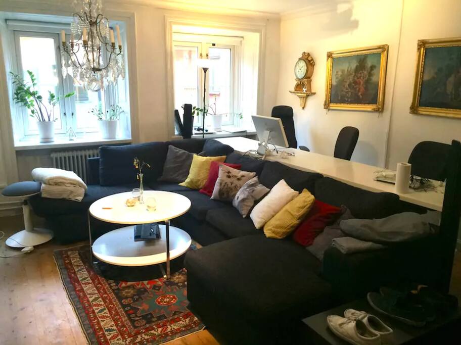 Our shared living room with projector, working space and windows toward the lively street of Västerlånggatan
