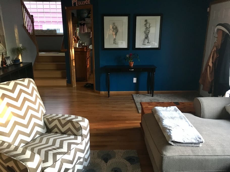 View of front entry way and stairs from living room.