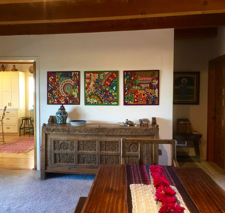Dining area decorated with locally made furniture and folk art from around the world.