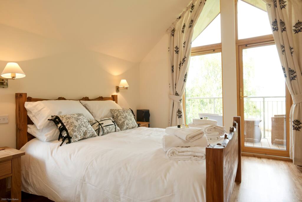 King-sized bedroom with doors to balcony