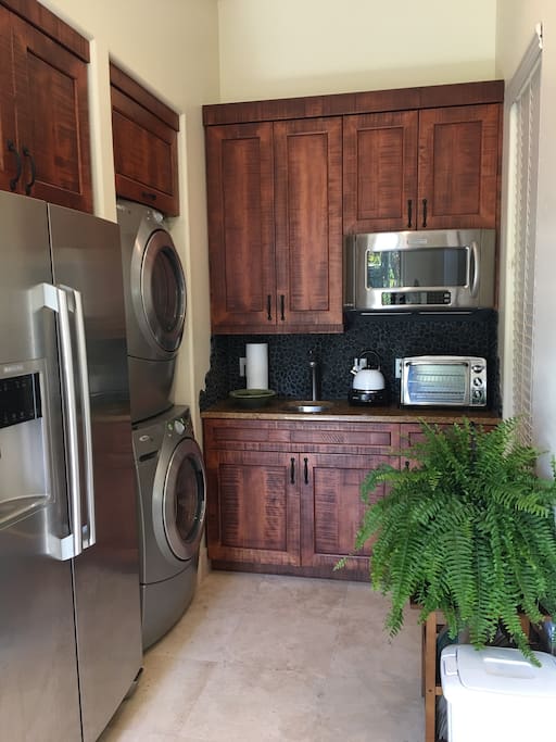 Kitchen with full fridge, washer/dryer, microwave, small convection oven, coffee maker & hot plate for cooking