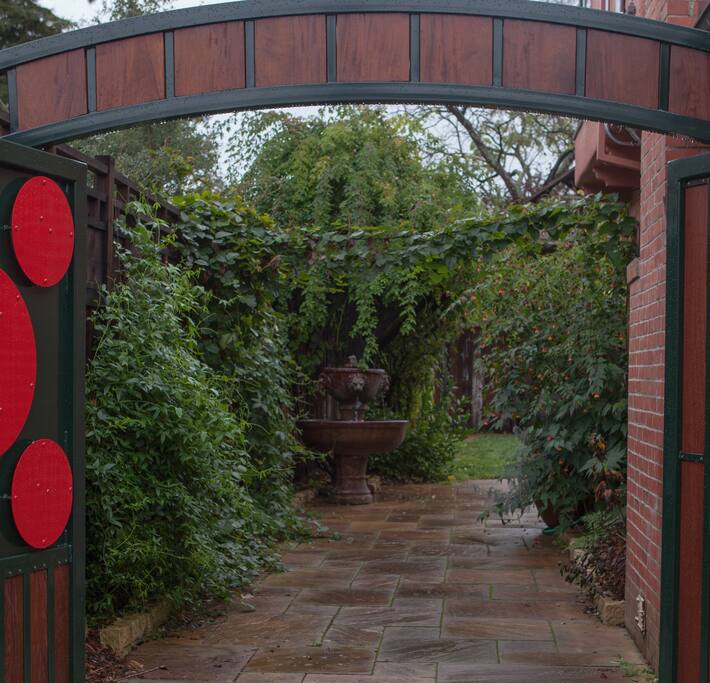 Secret garden entry through driveway gate.